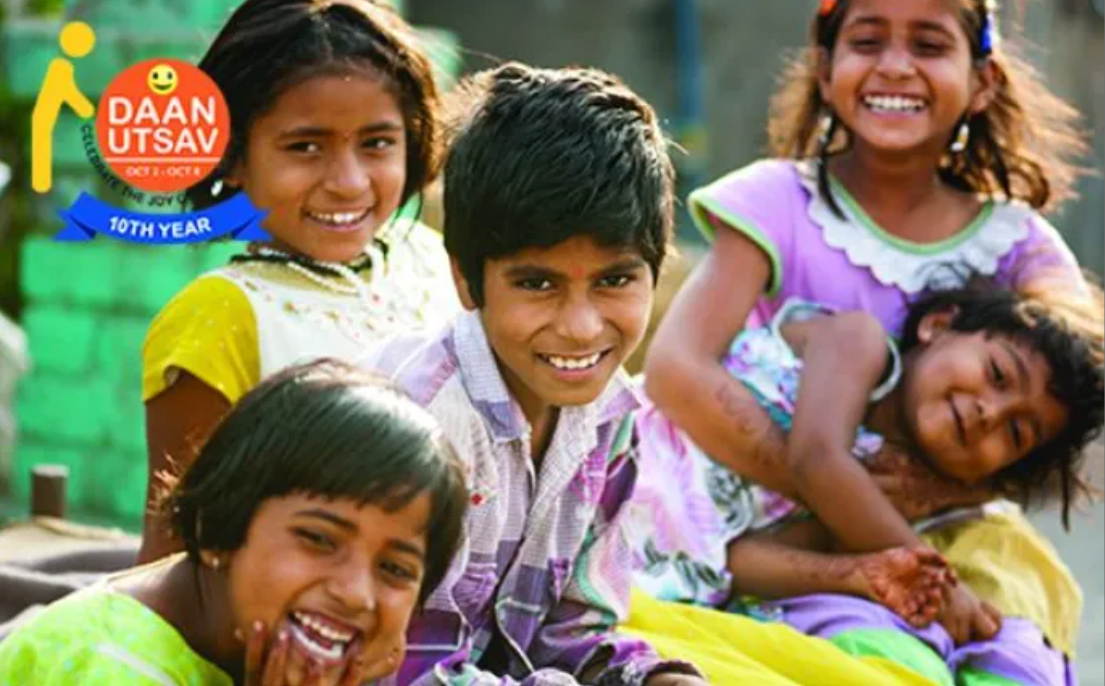 a group of smiling children with the Daan Utsav logo