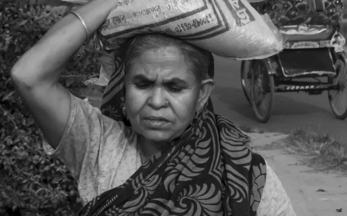 a woman carrying a sack