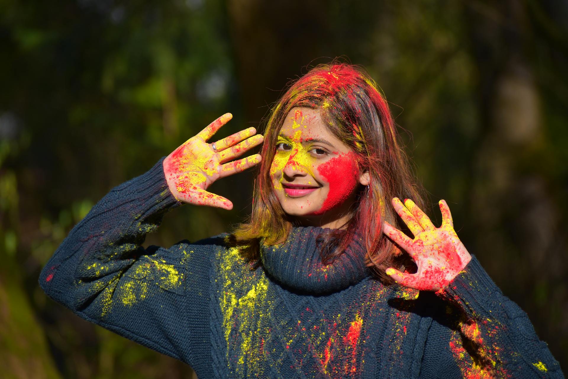 a young Indian woman playing Holi