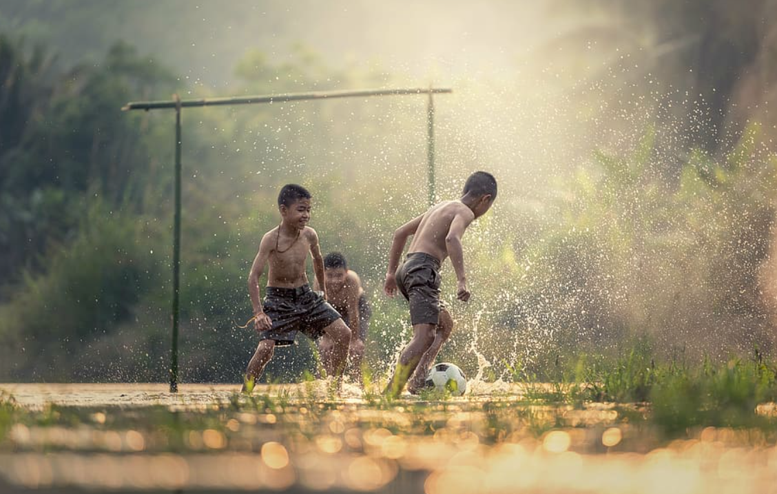 three young boys playing soccer