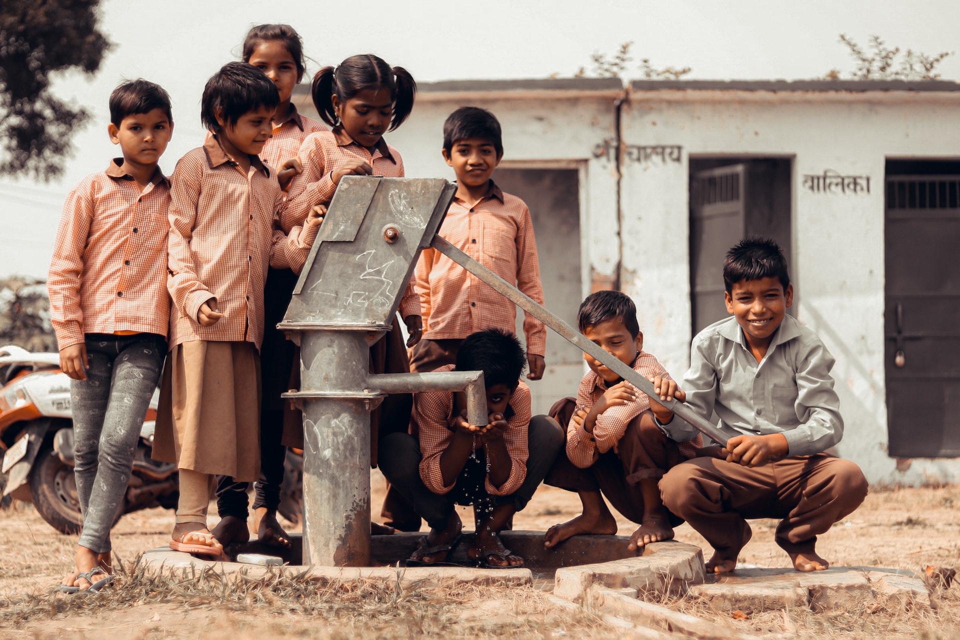 group of children in india playing near a water well