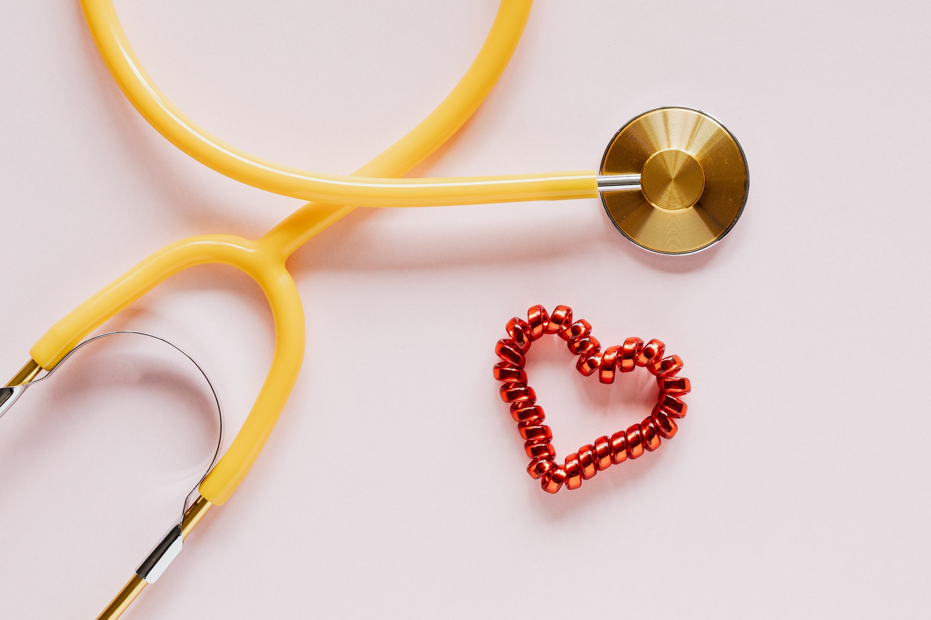 a stethoscope with a paper heart next to it