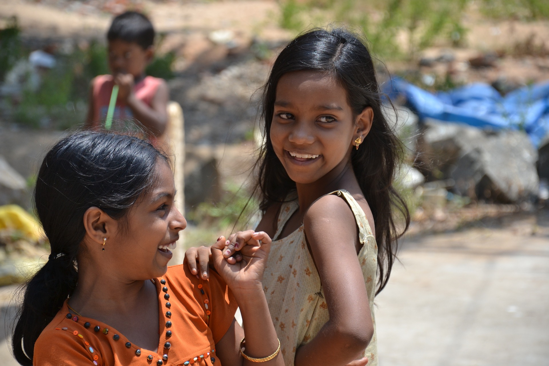 Two Indian children laughing with each other