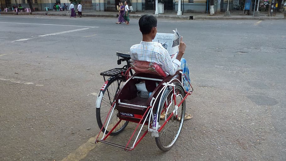 a man in a wheelchair reading a newspaper