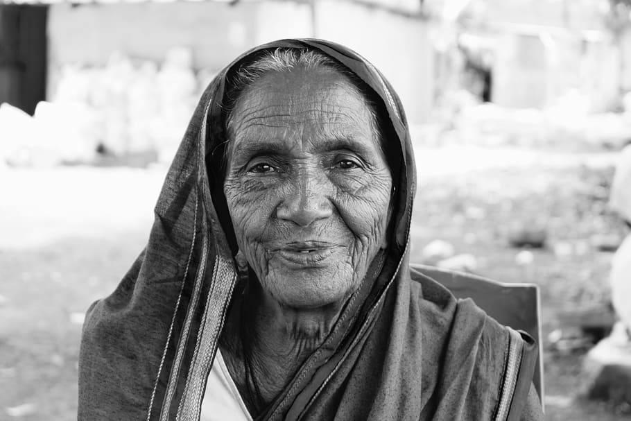 a black and white photo of an elderly woman in India