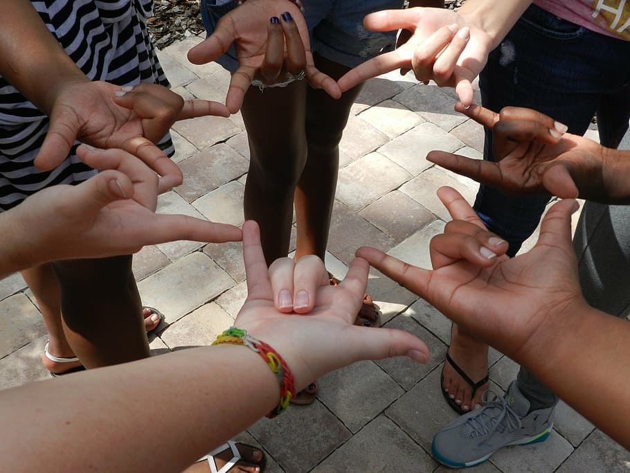 a group of people signing in sign language