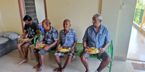 four senior citizens eating a meal at Jeevan Anand Sanstha
