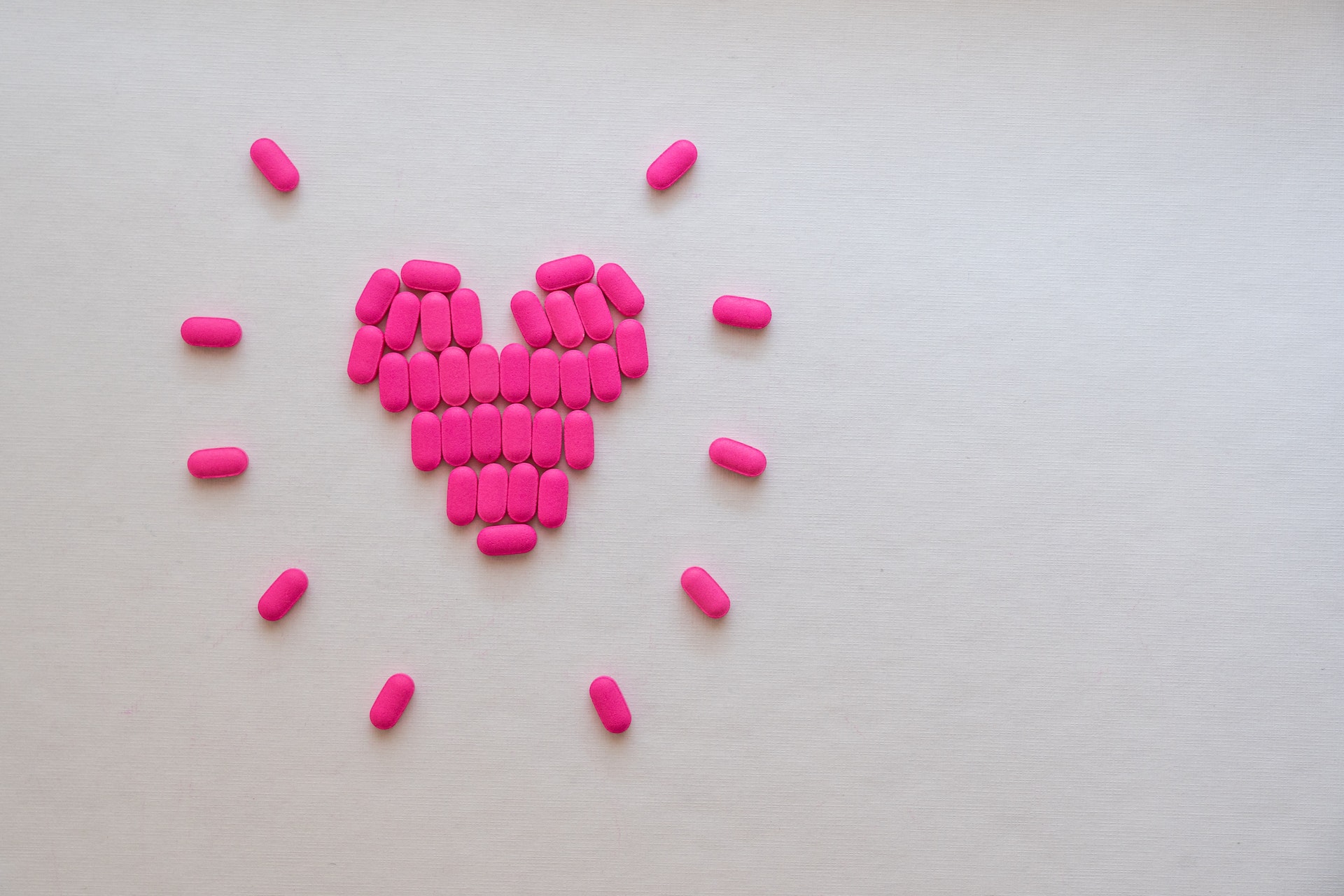 pink pills forming the shape of a heart