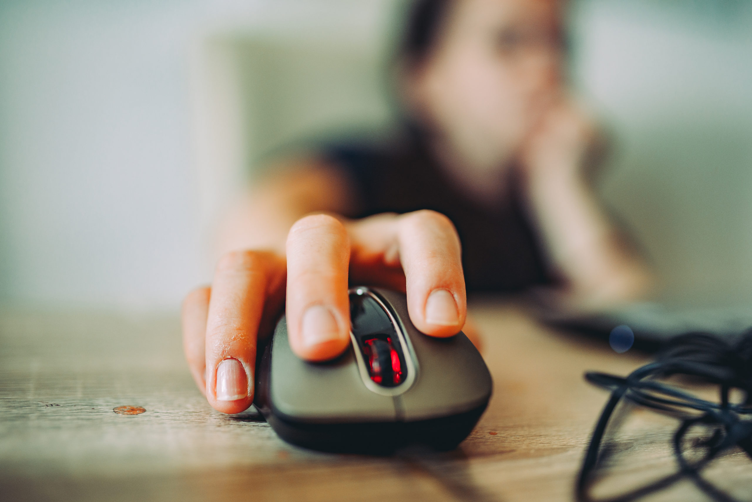 person on a computer clicking on a mouse