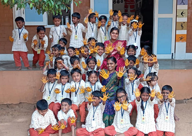 a teacher with her students at Isha Education