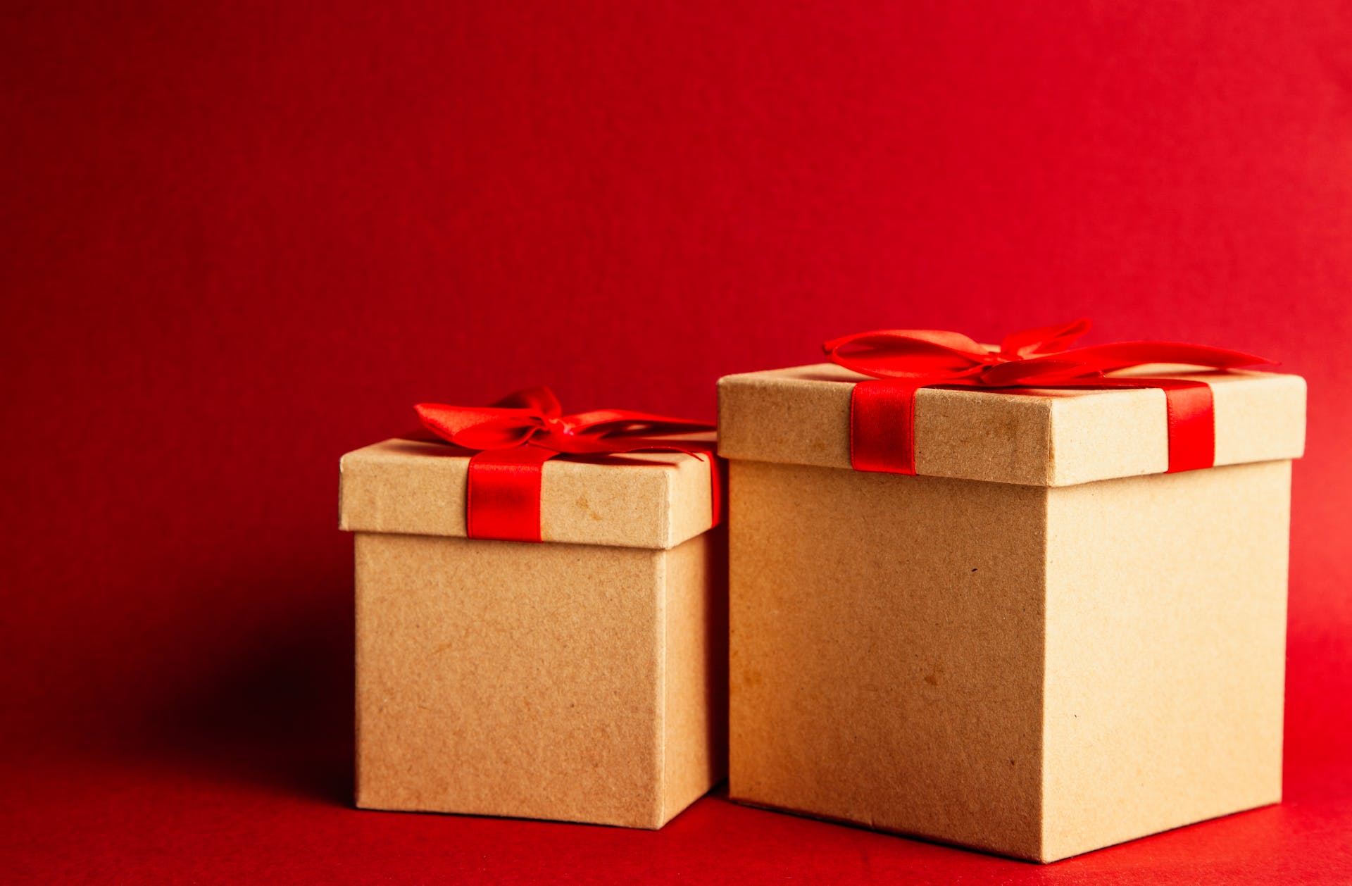 two wrapped presents against a red background