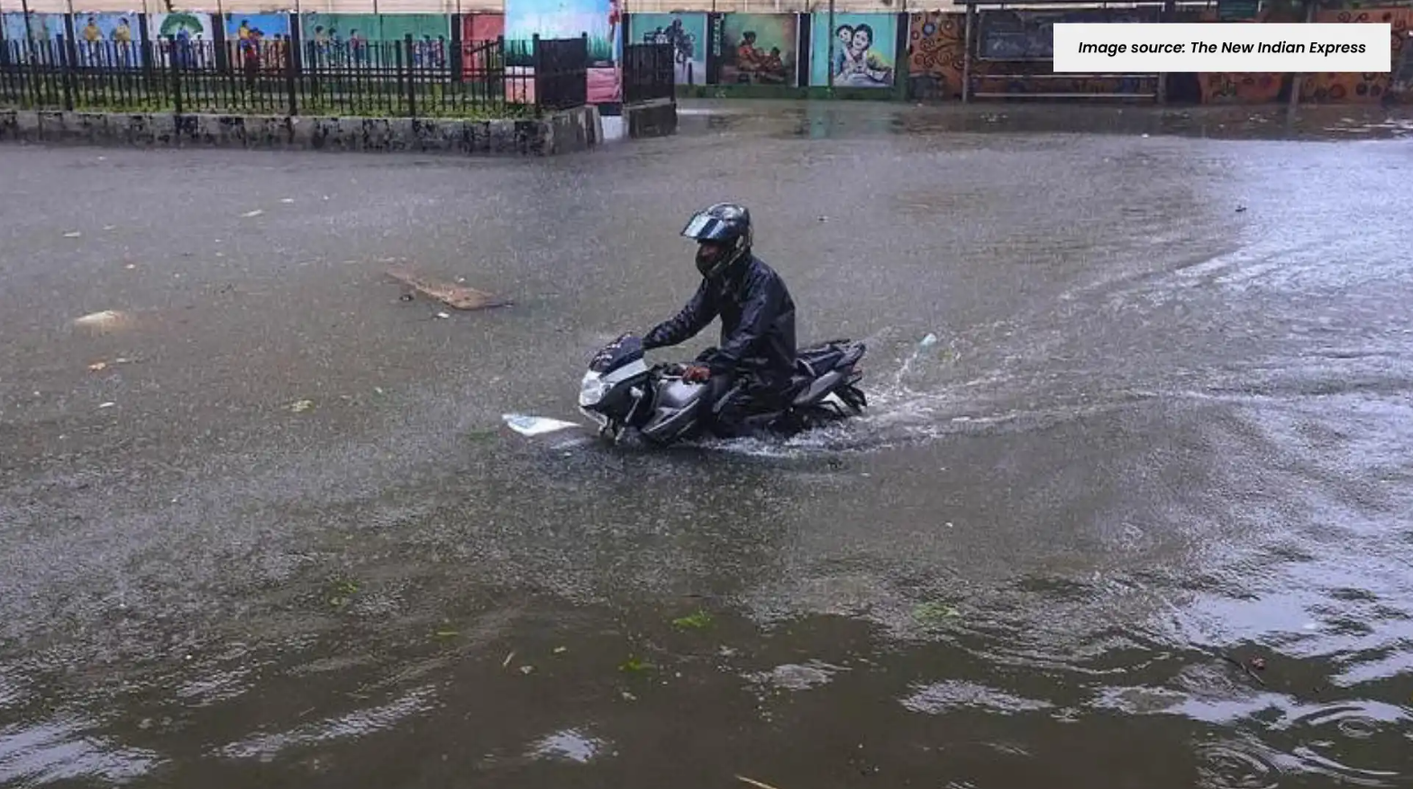 a man on a bike on a flooded street