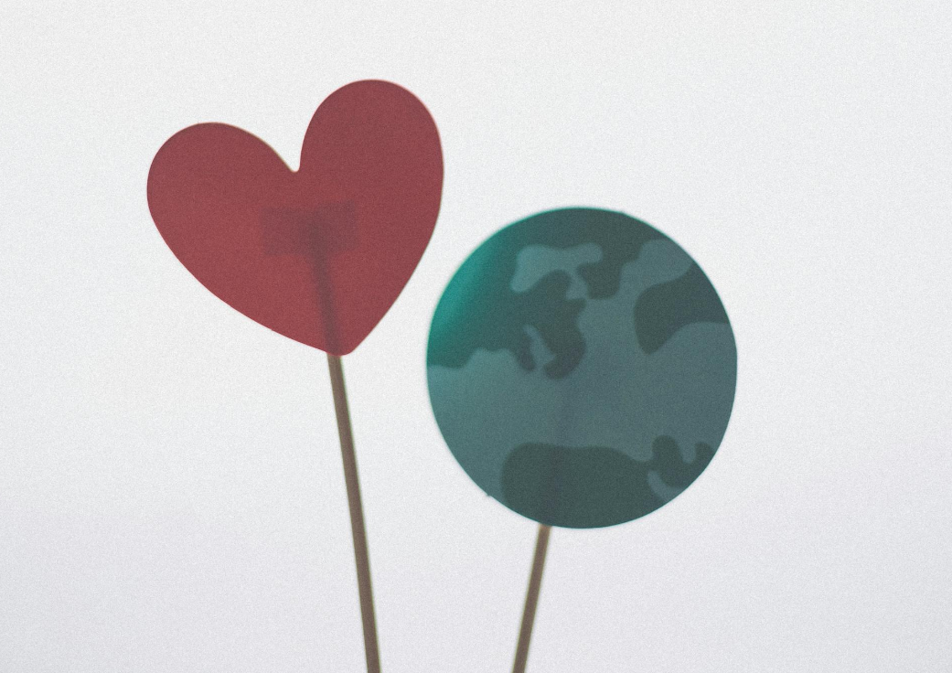 a paper heart with a paper Earth cutout