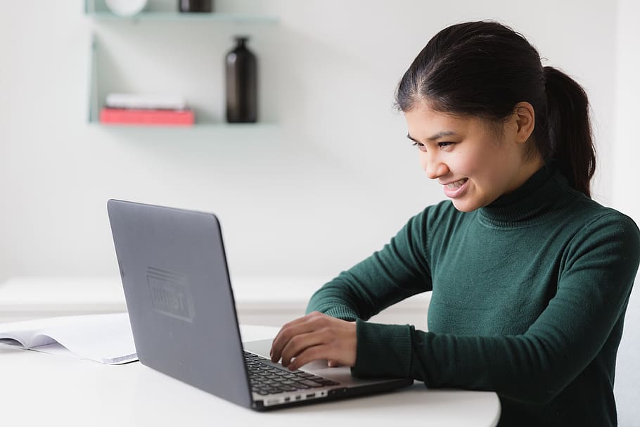 happy young woman on a laptop