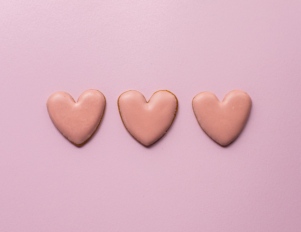 three pink hearts on a pink background