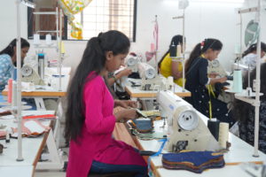 a group of women sewing with sewing machines