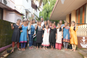 a group of children with the founder of an NGO