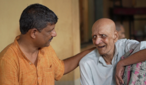 a young man comforting an old man