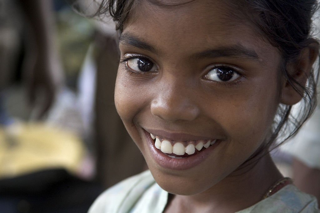 an Indian girl smiling at the camera