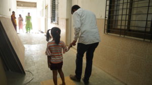 an adult helping a child rescued from sex trafficking