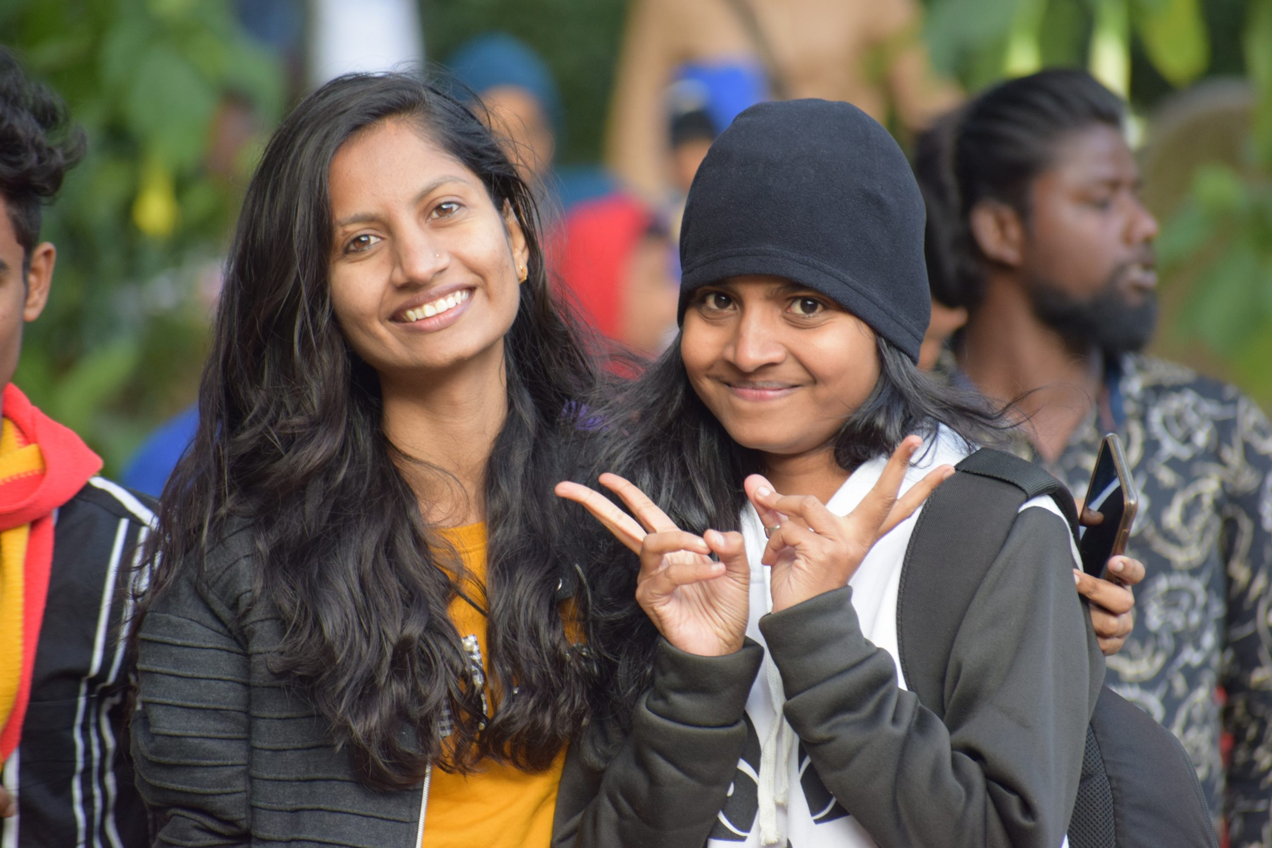two young Indian women smiling at the camera