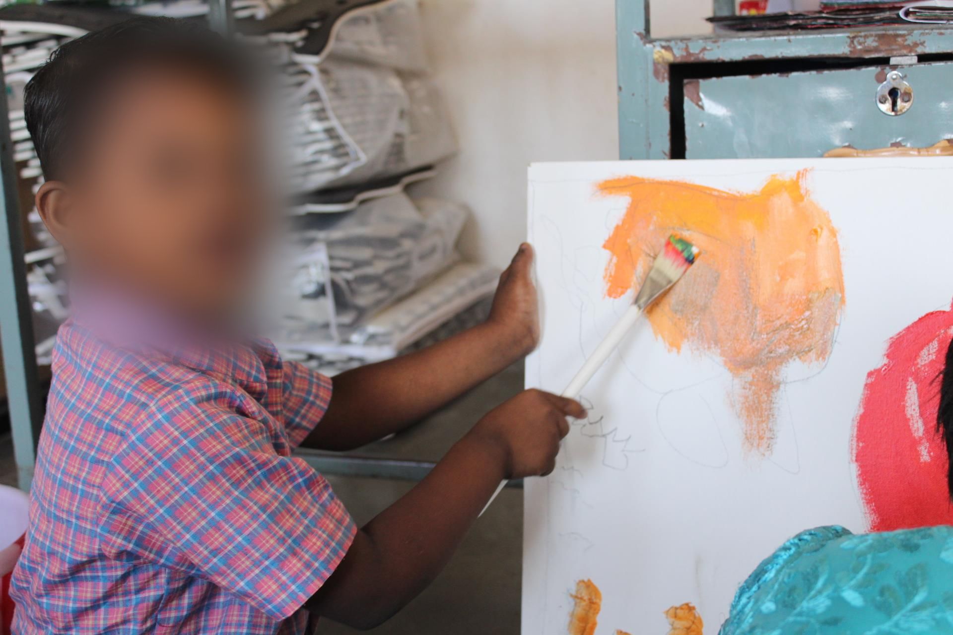 a boy with disabilities painting