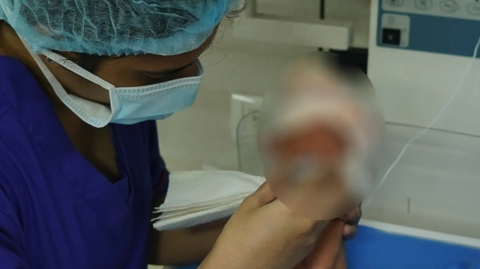 a doctor with a baby in the ICU