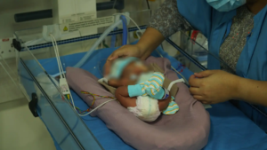 a doctor with a baby in the ICU