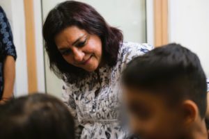 Priya Dutt looking at some children