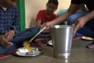 two children eating a meal