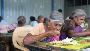 an elderly woman eating