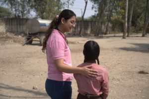 a woman standing with a young girl