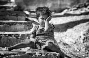 a child sitting outside and crying