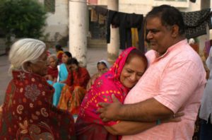 an old lady embracing a man