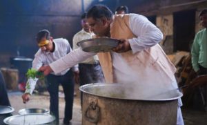 people in a kitchen cooking meals 