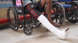 a boy in a wheelchair with a cast on his leg