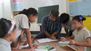 an NGO leader teaching students 
