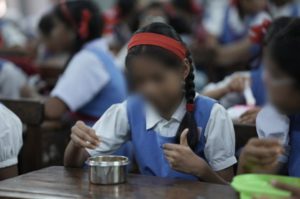 a group of school girls eating a meal