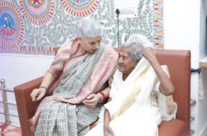 two women sitting and talking to each other