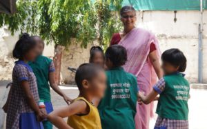 a woman playing with a group of children