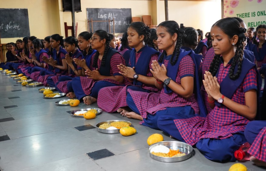 a group of school girls about to eat a meal