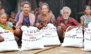 a group of elderly people with bags of food