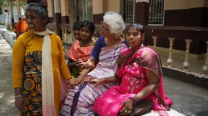 a group of women sitting outdoors