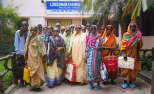 a group of eye patients outside a hospital